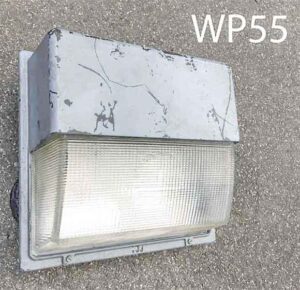 WP55-Qty-24.  Grey metal wall pack with glass. 16″W x15″ H.  Mogul base light bulb c/w cord
