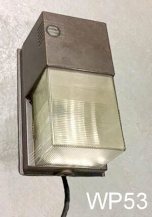 WP63-Qty-1. Brown metal wall pack with aged plastic front, and cord. 10" x 7"