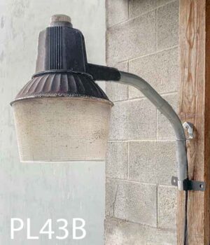 PL43B-Qty-3. Brown aged aluminum light with acrylic lens on pipe c/w cord. Light can either be tungsten or 150W high pressure sodium. Mounted on BR2-Qty-2.