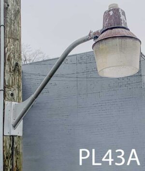 PL43A-Qty-3. Brown aged aluminum light with acrylic lens and cord. Light can be either tungsten or 150W high pressure. Mounted on BR1-Qty-4. Grey light bracket.40" long, 35"out.